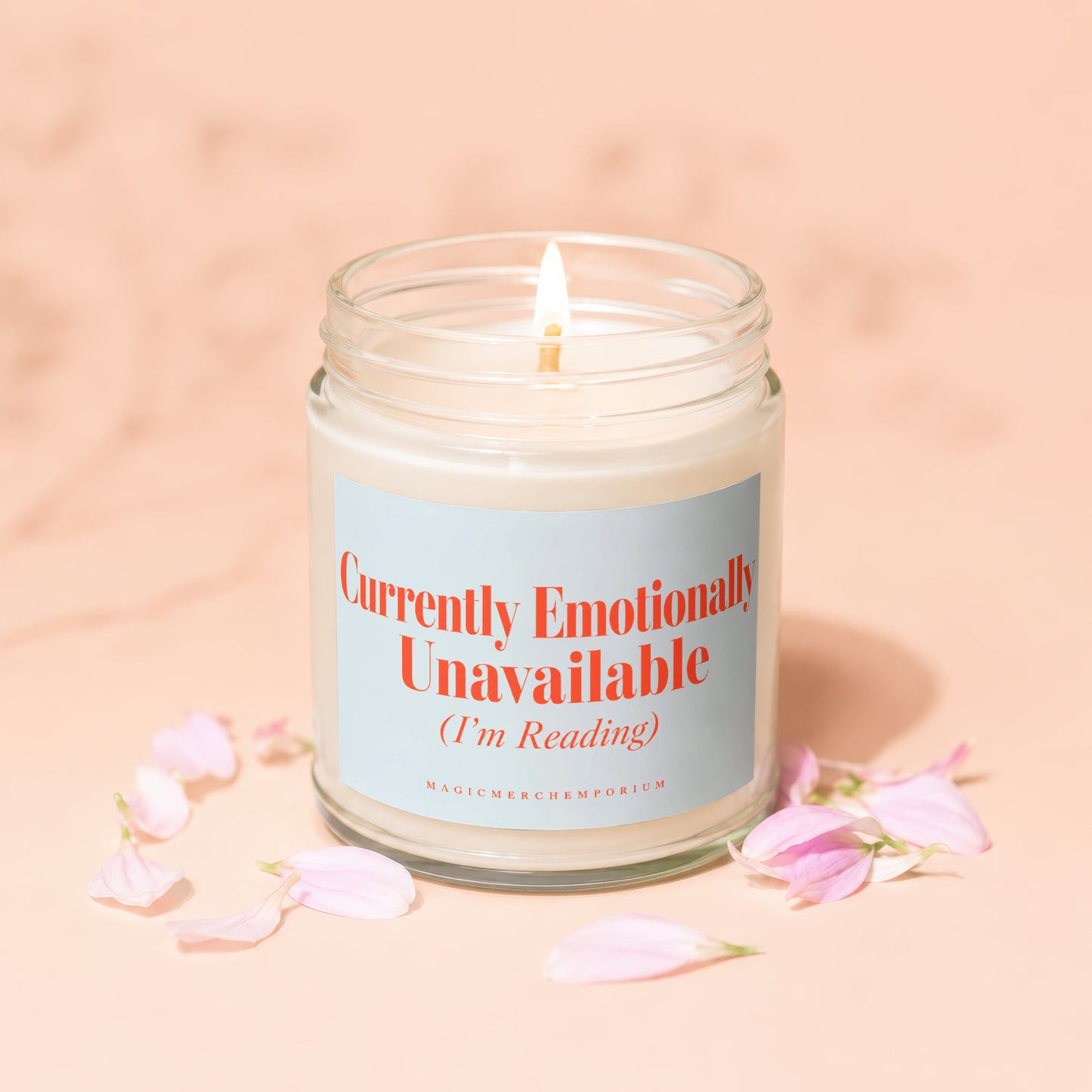 Candle with "Currently Emotionally Unavailable (I'm Reading)" text, surrounded by flower petals.