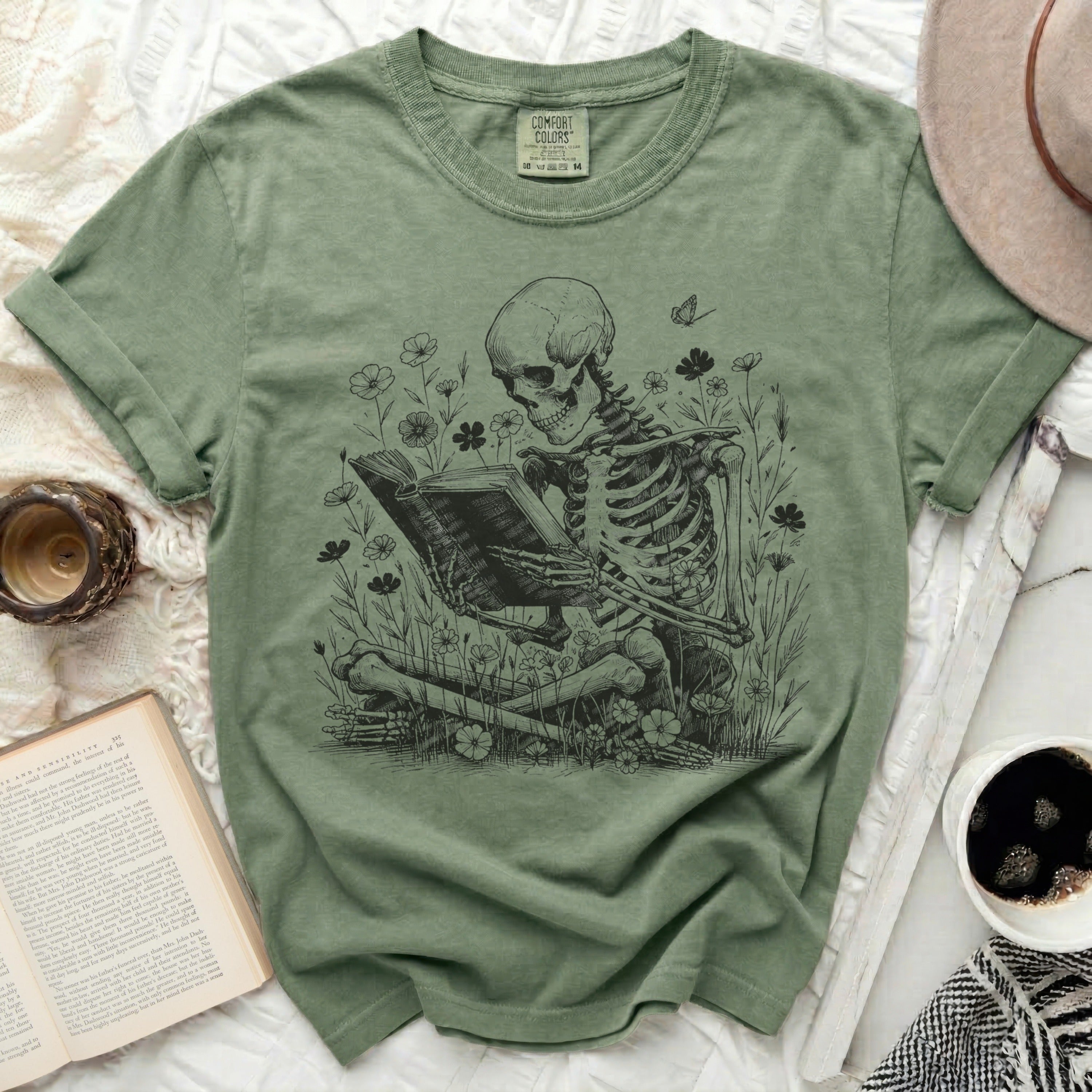Skeleton reading a book in a field of flowers with a butterfly.