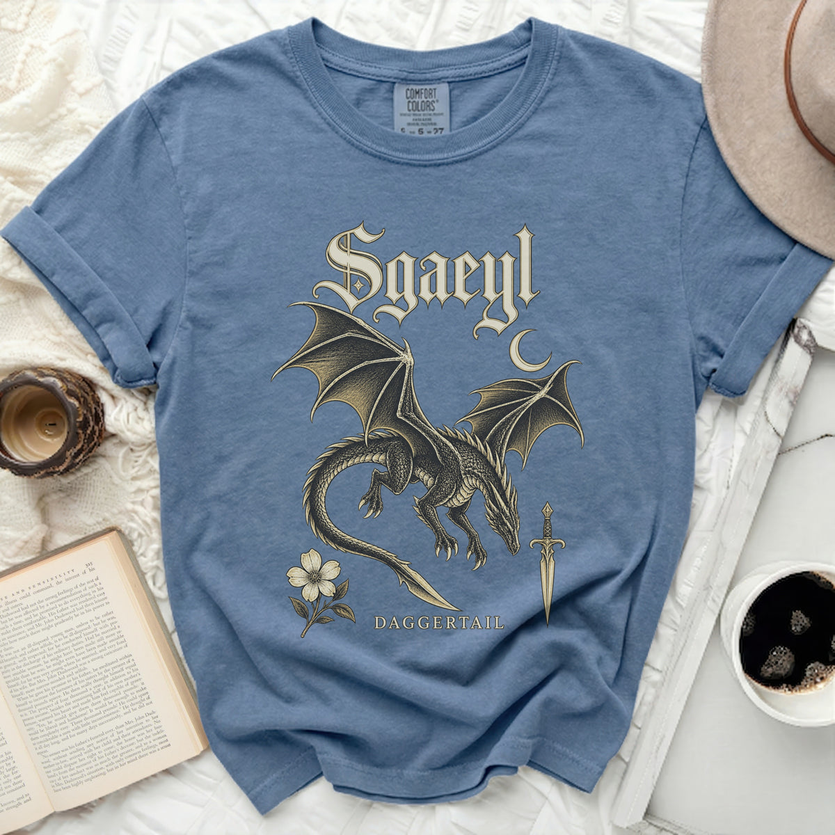 Blue t-shirt with a dragon, sword, flower, and "Sgaeyl Daggertail" text.