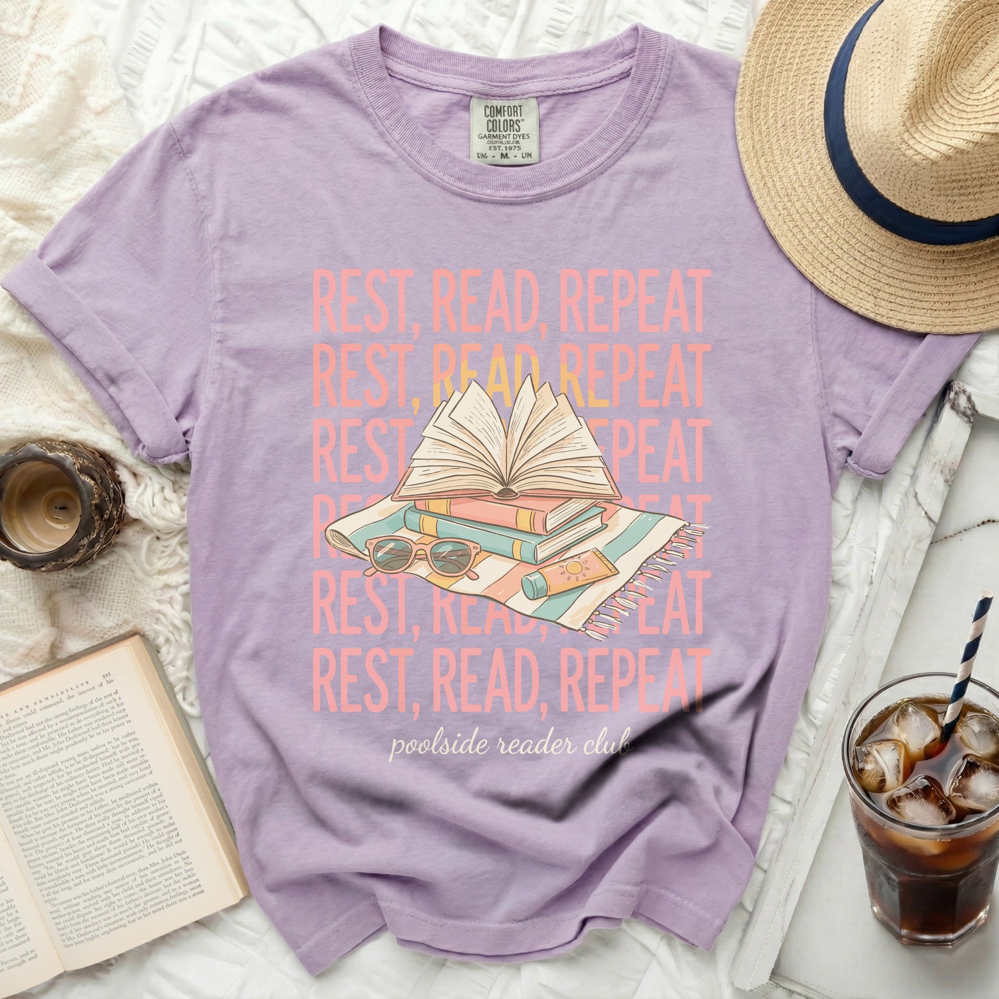 Purple t-shirt with "Rest, Read, Repeat" text and book graphics.
