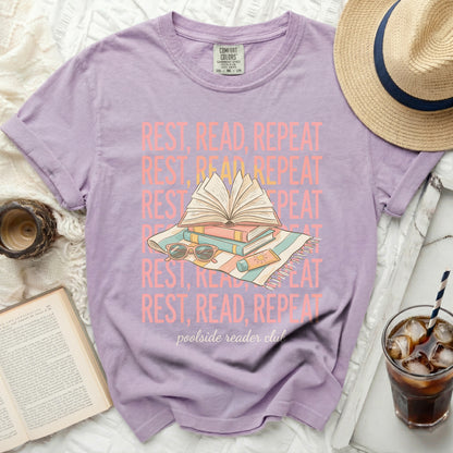 Purple t-shirt with "Rest, Read, Repeat" text and book graphics.