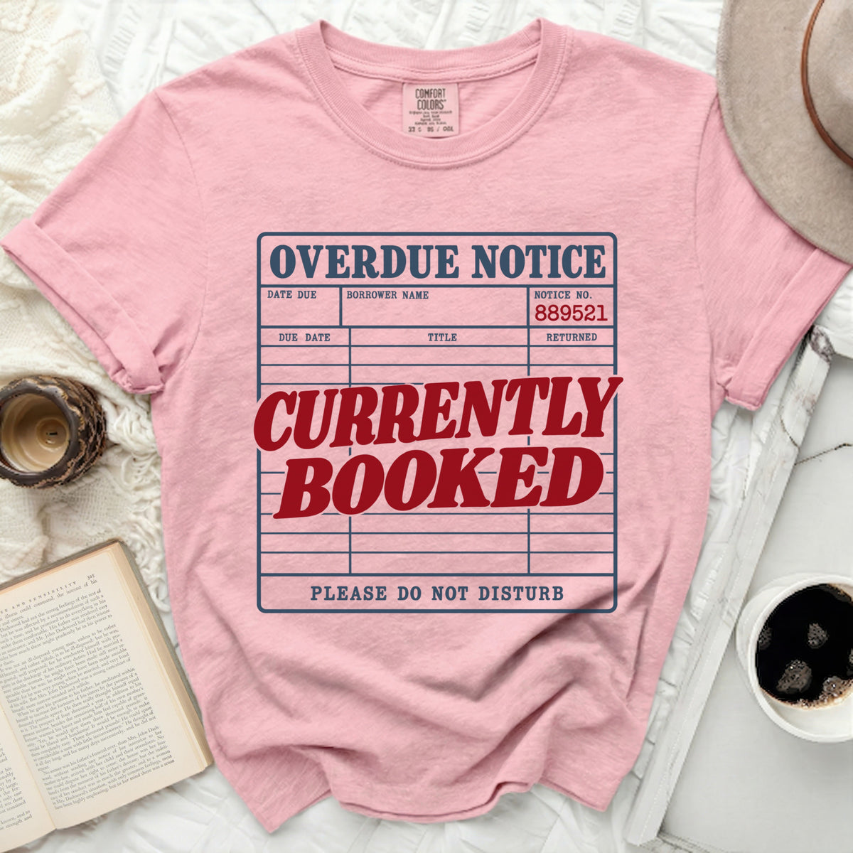 Pink t-shirt with "OVERDUE NOTICE CURRENTLY BOOKED PLEASE DO NOT DISTURB" graphic.