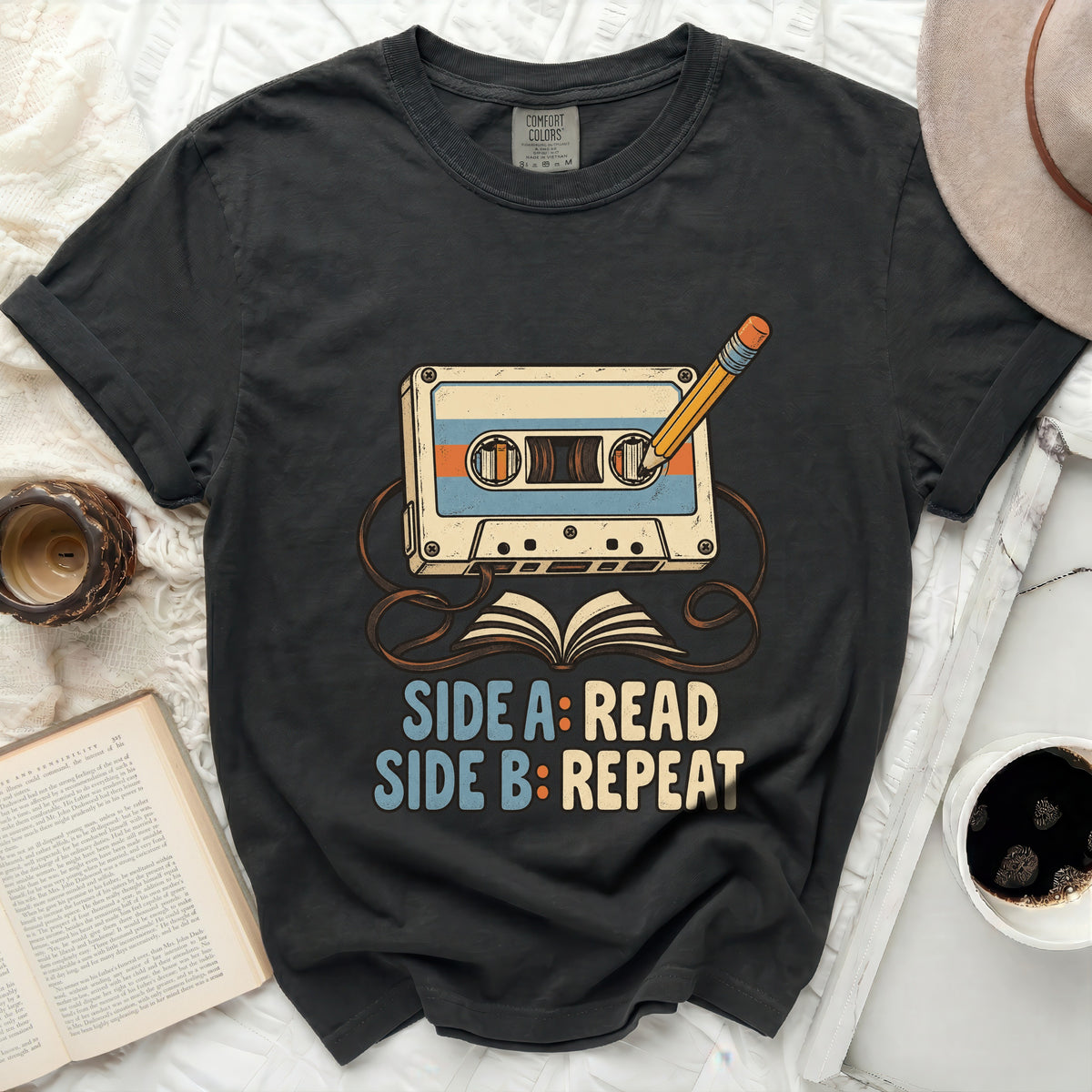 T-shirt graphic with cassette tape, pencil, and text "SIDE A: READ SIDE B: REPEAT".