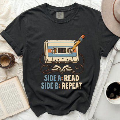 T-shirt graphic with cassette tape, pencil, and text "SIDE A: READ SIDE B: REPEAT".