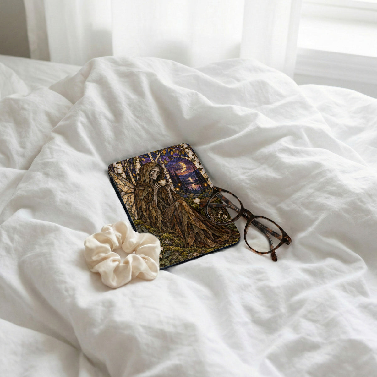 Fairy sits with tea on a forest night landscape case next to glasses.