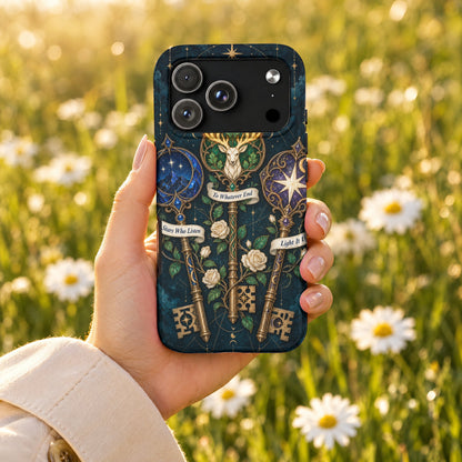 A hand holds a dark blue phone case featuring fantasy keys, roses, and inspirational banners.