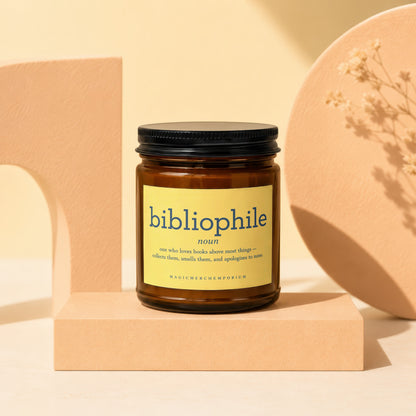 Brown glass candle with yellow label describing "bibliophile" and its definition.