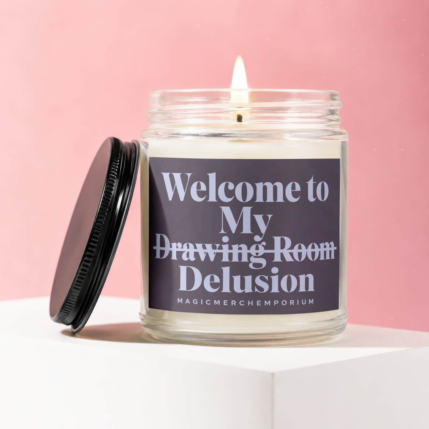 Candle with "Welcome to My Drawing Room Delusion" text inscribed on the label.