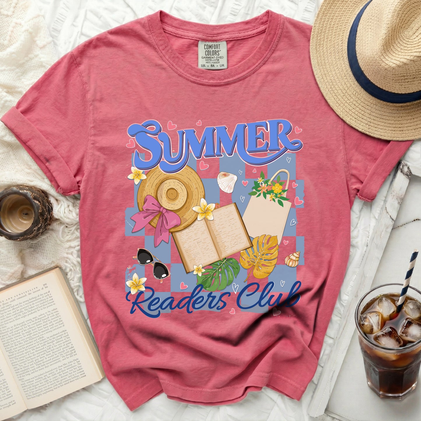Pink t-shirt with "SUMMER Readers Club" graphic featuring a straw hat, book, and beach elements.