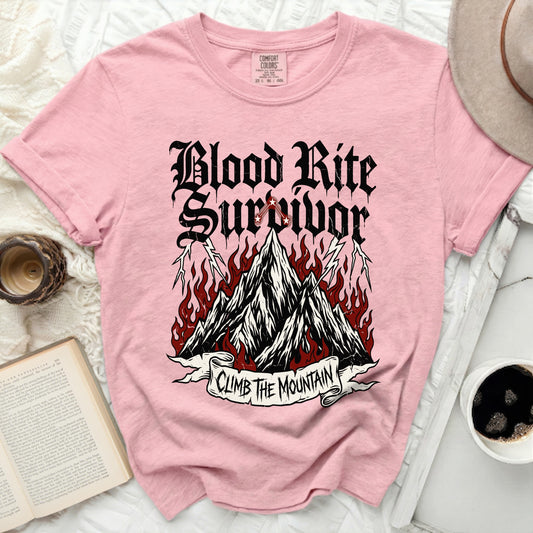 Pink t-shirt with "Blood Rite Survivor Climb The Mountain" graphic.