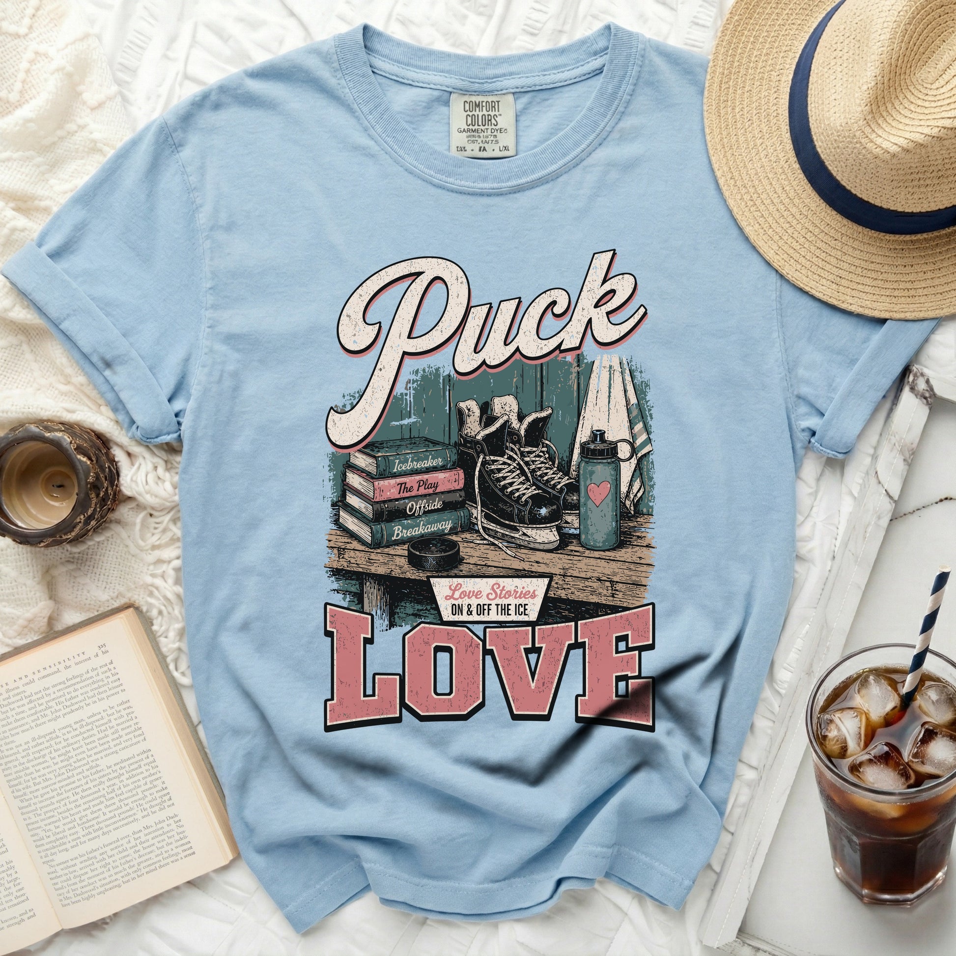 Light blue t-shirt with "Puck Love On & Off The Ice" text and hockey gear.