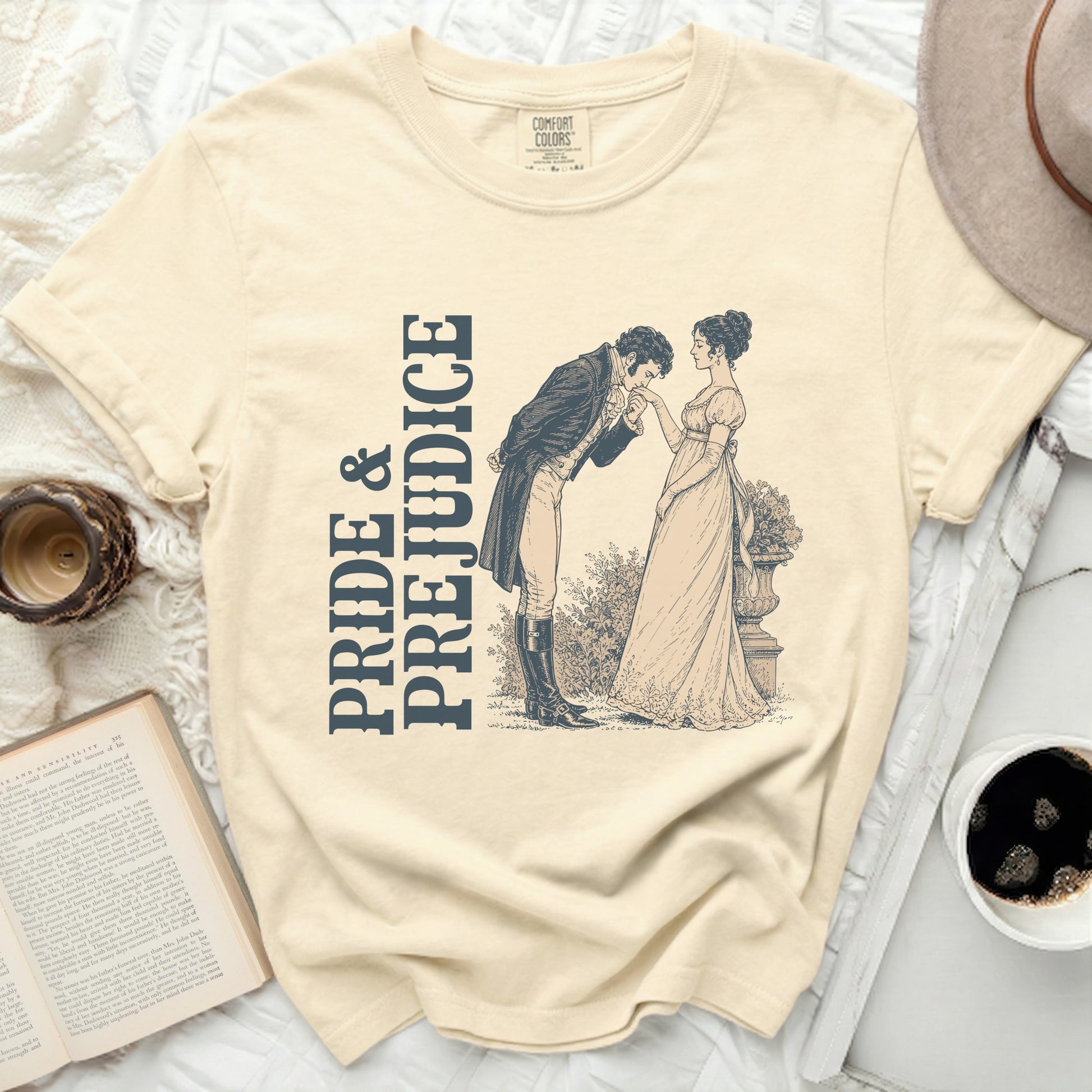 Cream t-shirt with "Pride & Prejudice" text and vintage illustration.