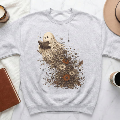 Ghost reading a book surrounded by autumn flowers and leaves on a gray sweatshirt.