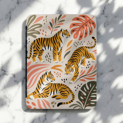Three tigers in different poses on a cream background with coral and green botanical elements.
