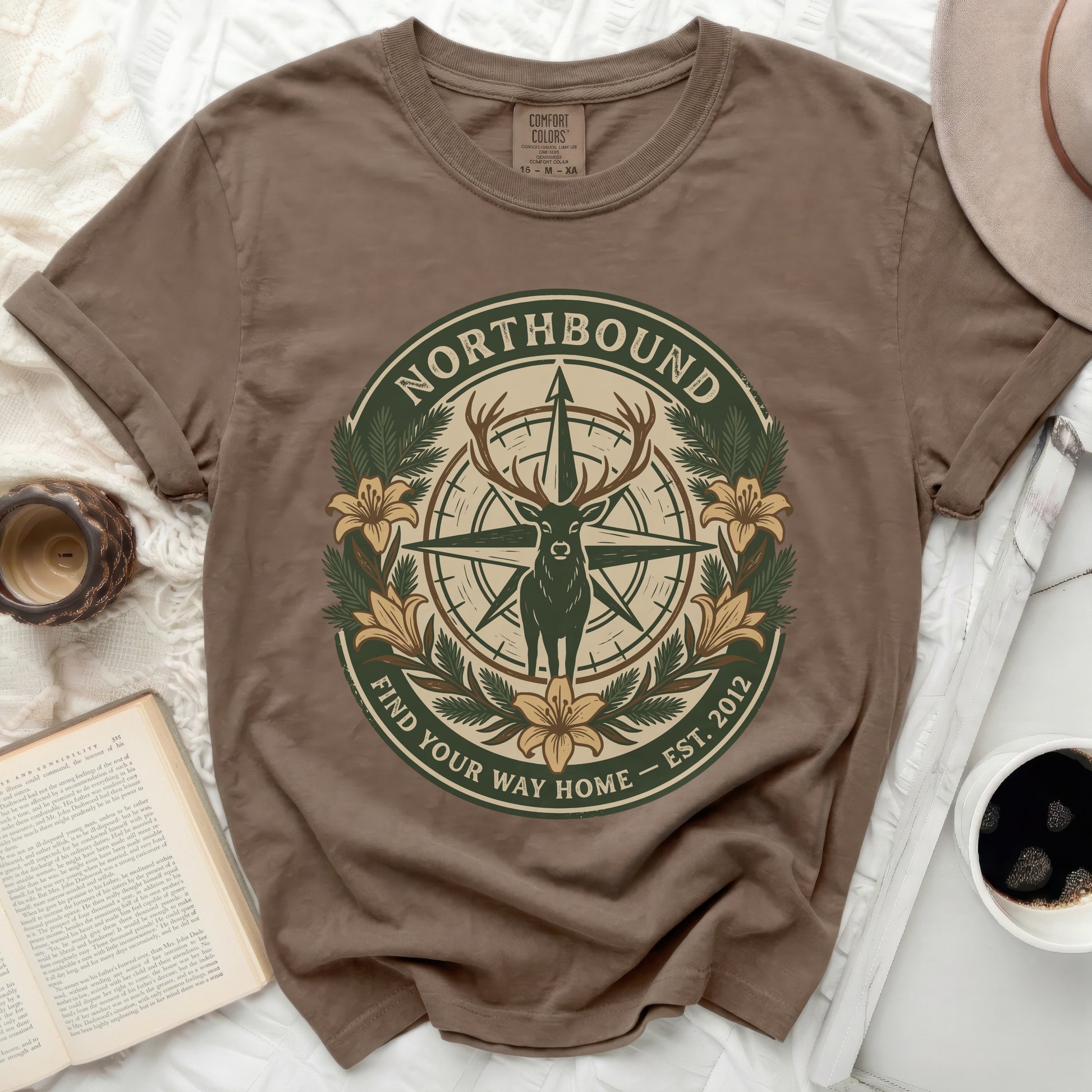 Brown t-shirt with compass, deer, flowers, and "Northbound Find Your Way Home" text.
