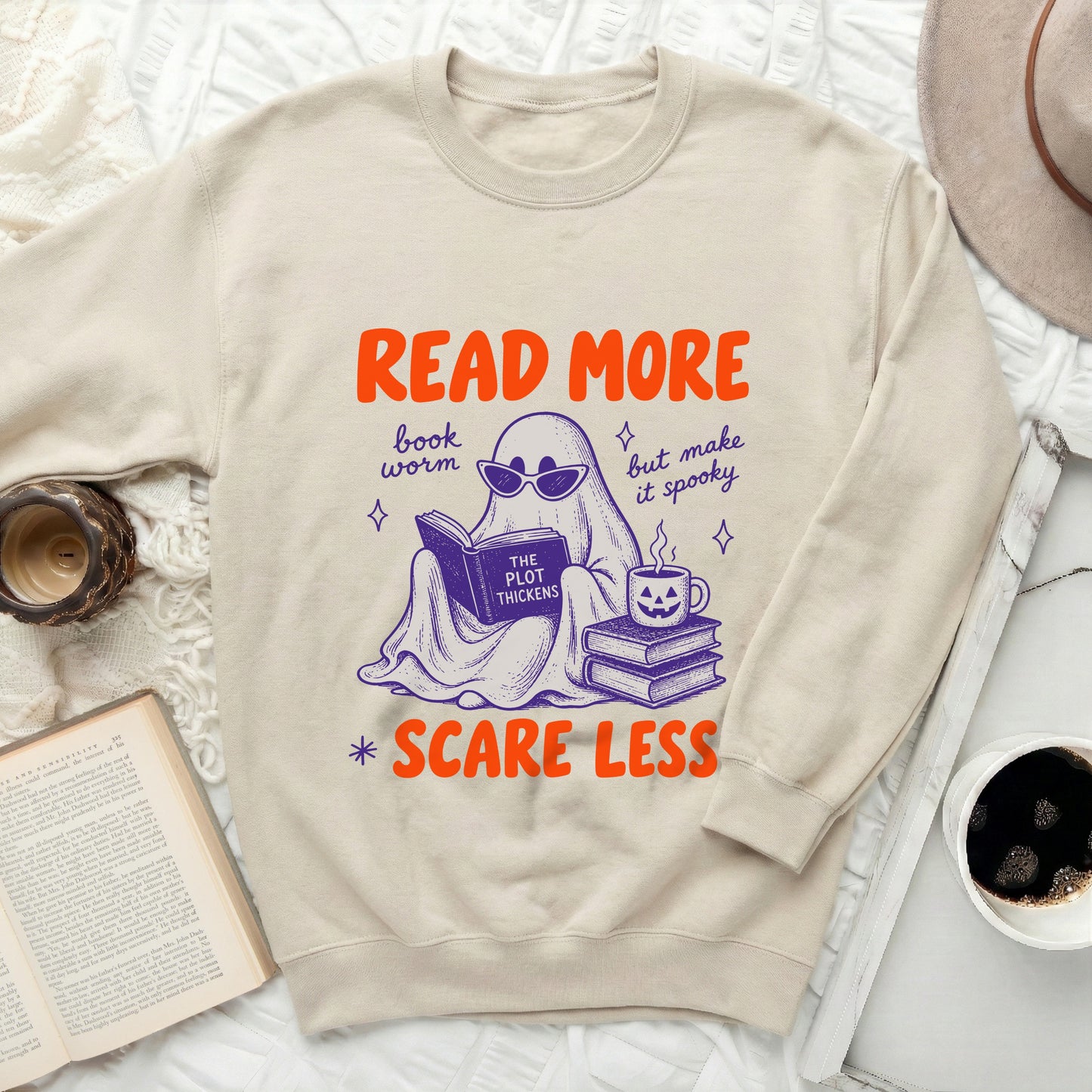 Light tan crewneck sweatshirt with "Read More" ghost reading and spooky coffee.