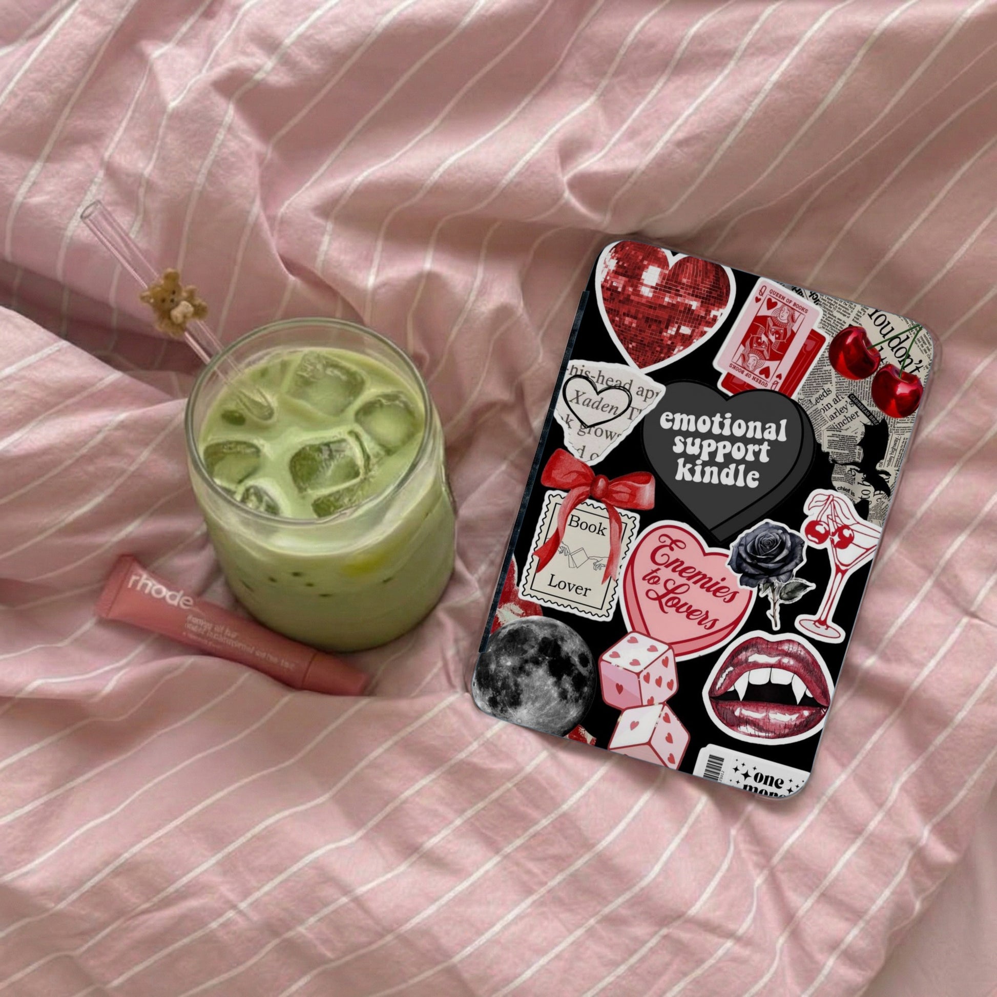 Kindle case with "emotional support kindle" text next to a matcha drink.