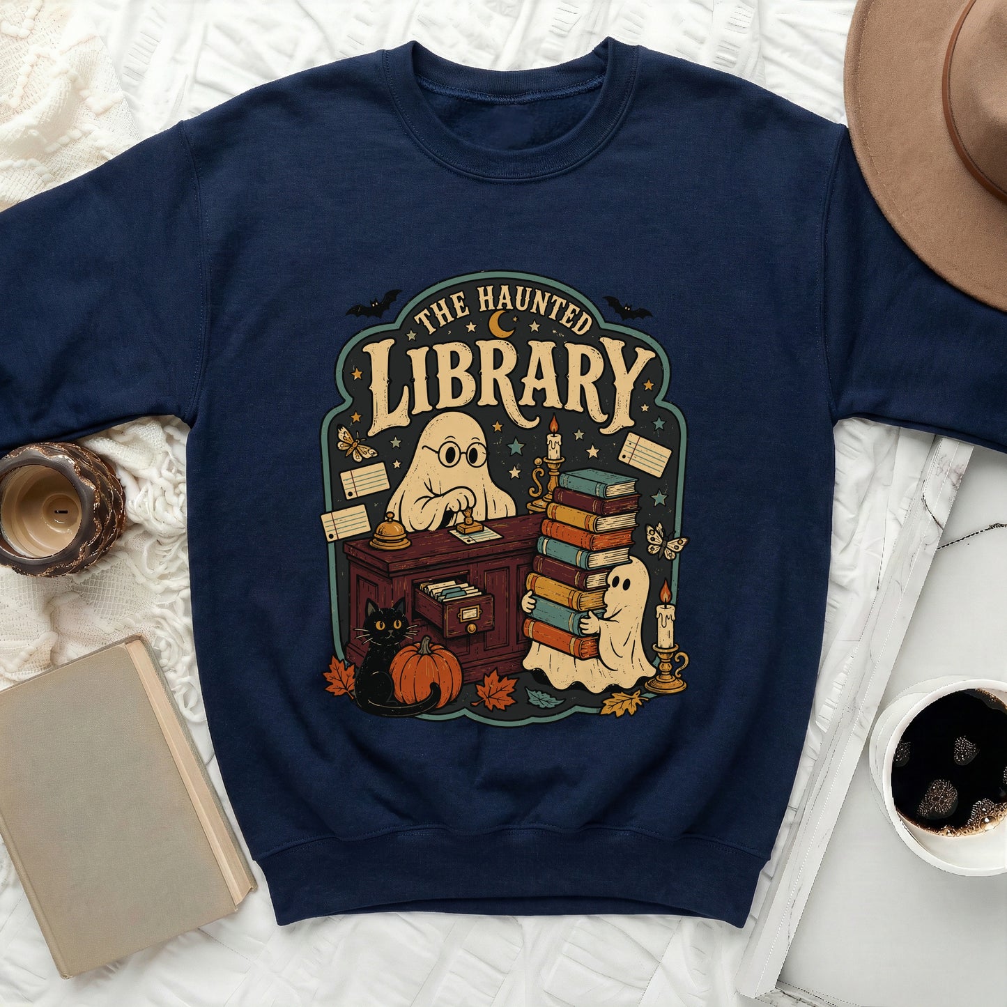 Navy sweatshirt with "The Haunted Library" graphic featuring ghosts, books, and a black cat.