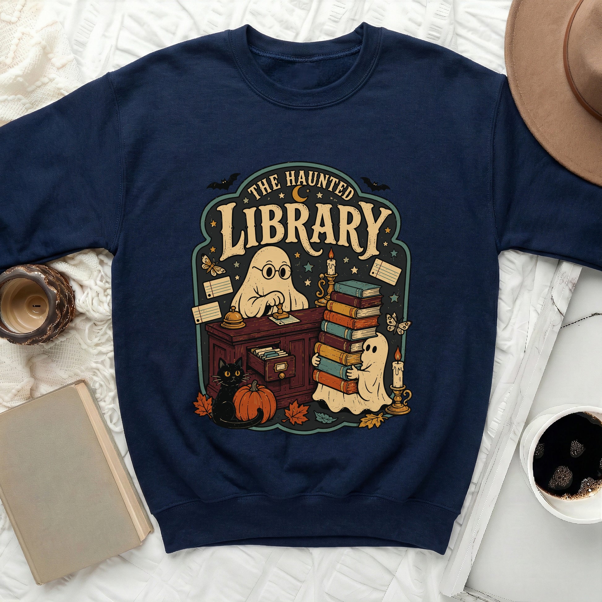 Navy sweatshirt with "The Haunted Library" graphic featuring ghosts, books, and a black cat.