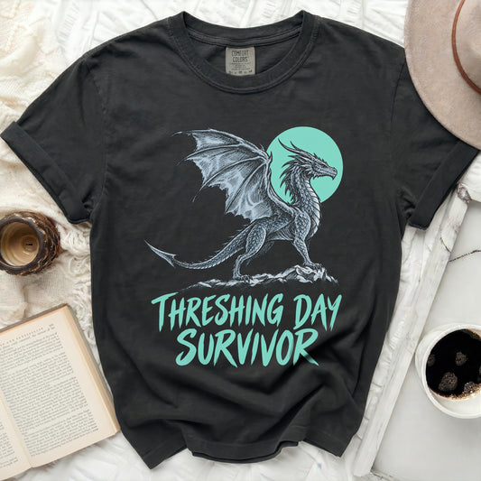 Black t-shirt with a dragon graphic and "THRESHING DAY SURVIVOR" text.