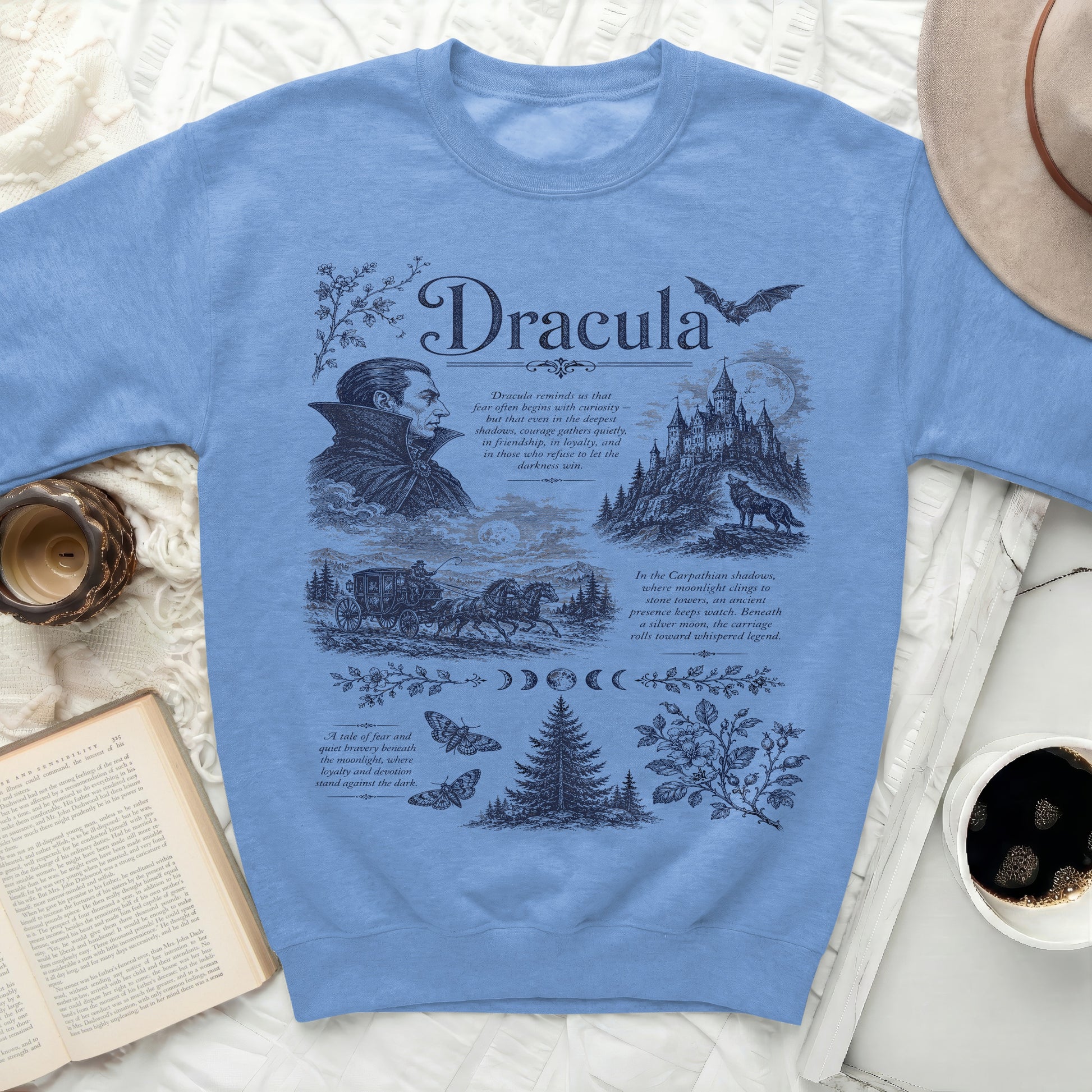 Blue sweatshirt with a dark blue graphic of Dracula, castle, carriage, and text.