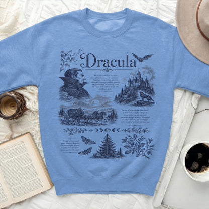 Blue sweatshirt with a dark blue graphic of Dracula, castle, carriage, and text.