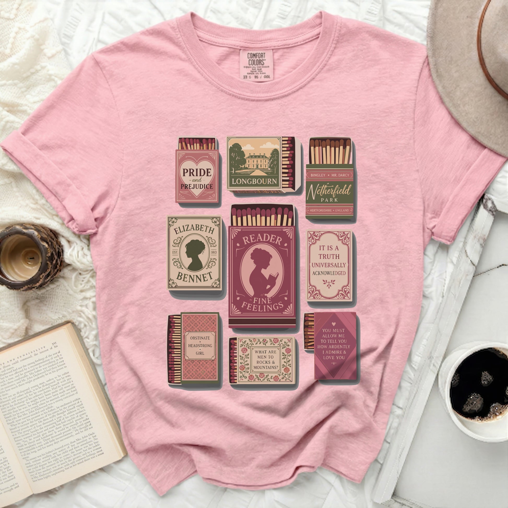 Pink t-shirt with a graphic of book-themed matchboxes.