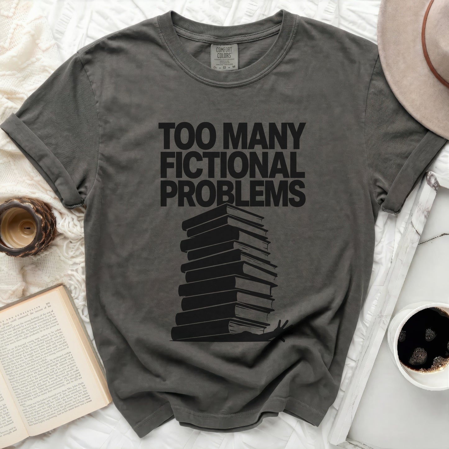 Dark grey t-shirt with stack of books and text "TOO MANY FICTIONAL PROBLEMS".