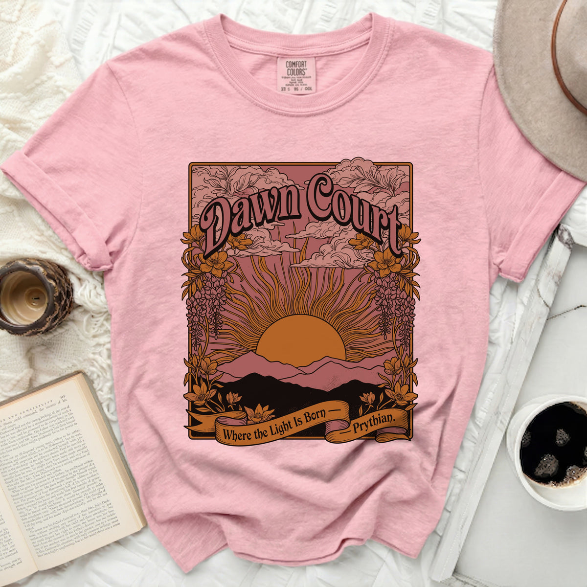 Pink t-shirt with "Dawn Court" and "Where the Light Is Born - Prythian" graphic.
