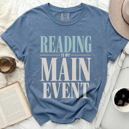 Blue t-shirt with "Reading is my main event" graphic.
