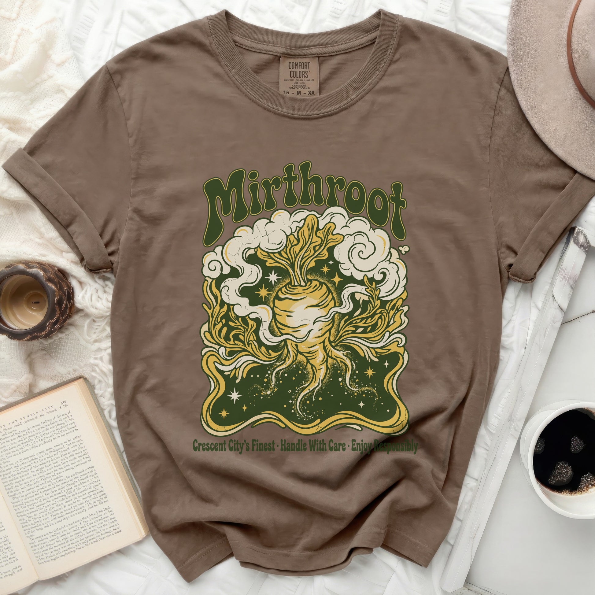 Brown t-shirt with circular graphic of root vegetable, clouds, and stars.
