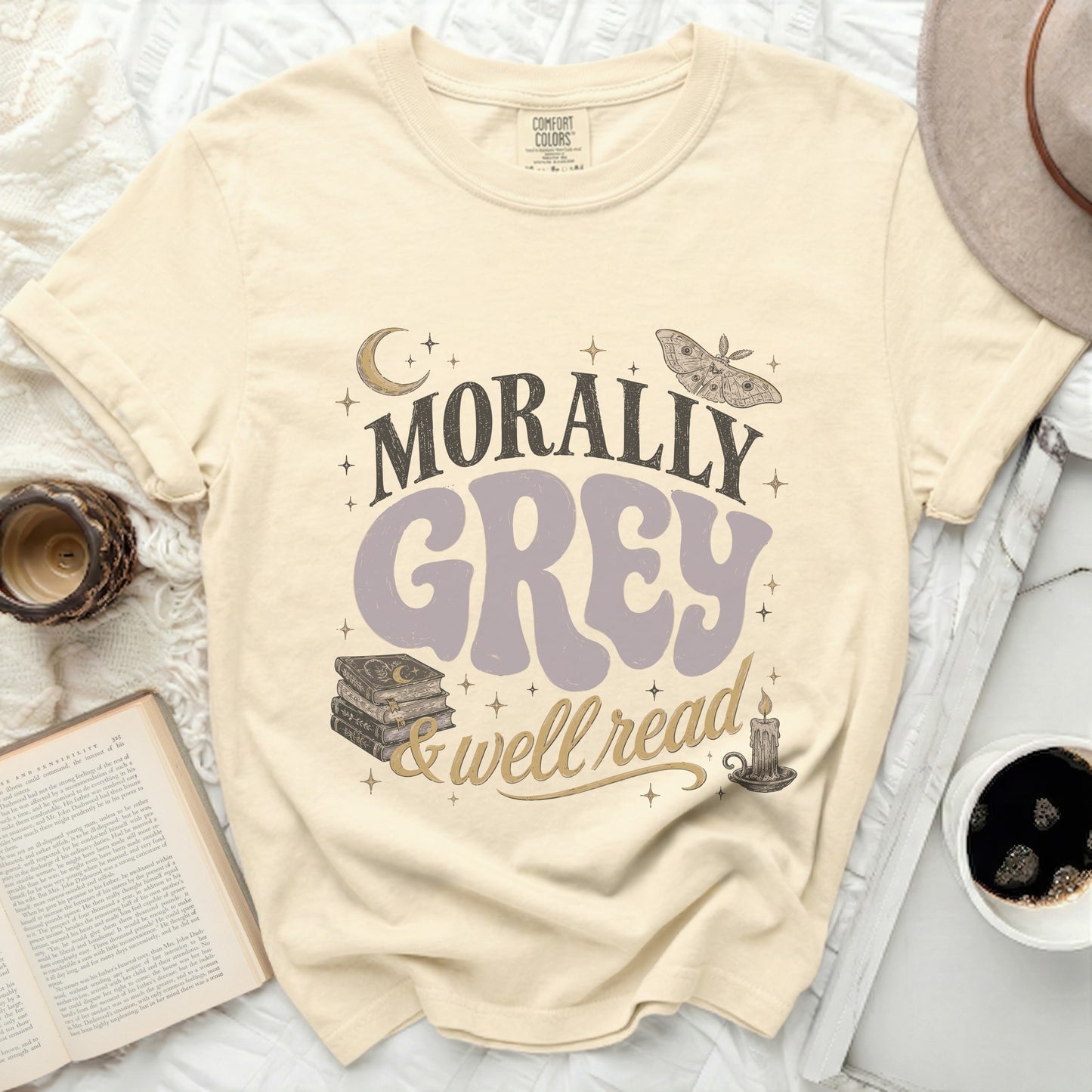 Morally grey & well read graphic tee with moon, stars, moth, books, and candle.