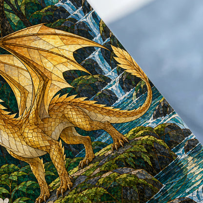 Golden dragon with wings spread, perched on rocks with a waterfall in background.