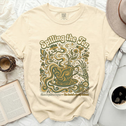Cream t-shirt with "Spilling the Tea" design featuring a teacup and skeleton hand.