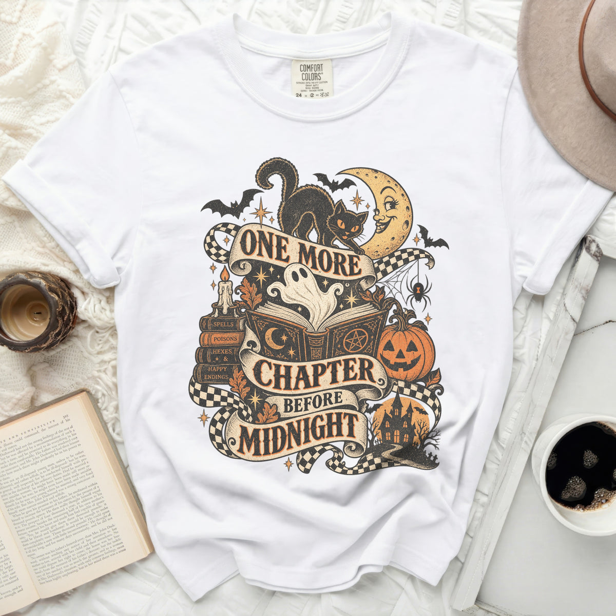 White t-shirt with "One More Chapter Before Midnight" Halloween graphic.