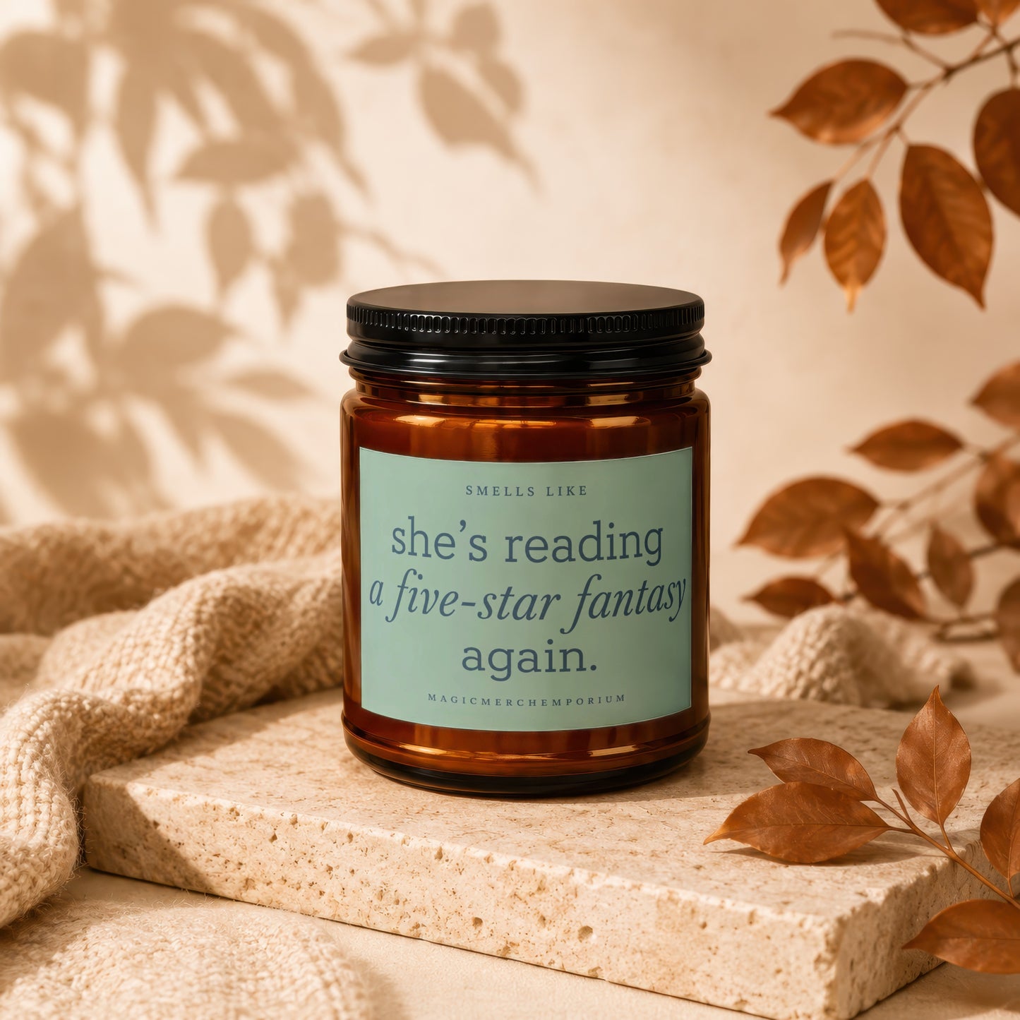 Candle labeled "she's reading a five-star fantasy again." with MAGICMERCHMPOIRUM.