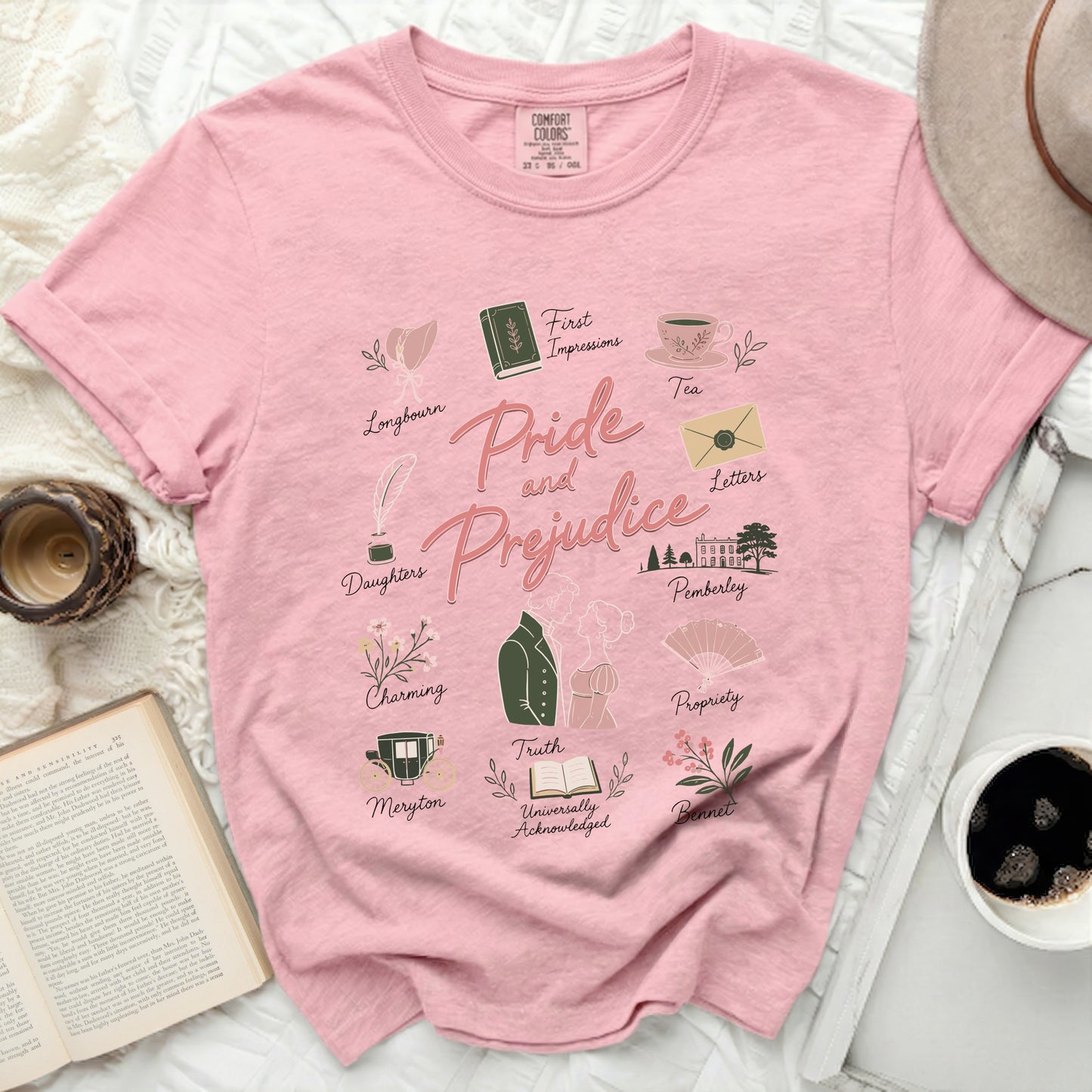 Pink t-shirt with "Pride and Prejudice" design and literary icons.