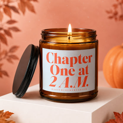 Amber jar candle with lit flame, white label reads "Chapter One at 2 A.M."