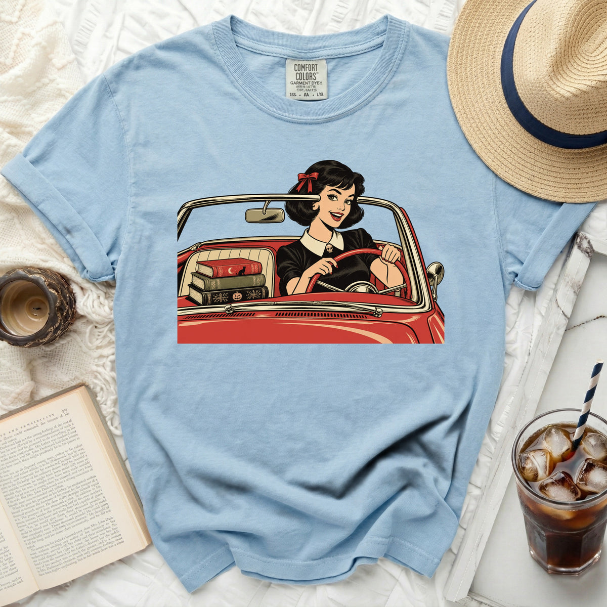 Light blue Comfort Colors t-shirt with graphic of a woman in a red car.