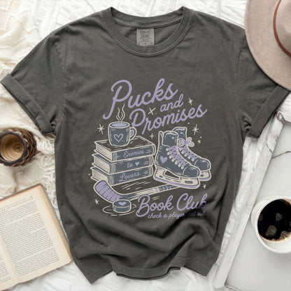 Dark gray t-shirt with "Pucks and Promises Book Club" text and graphic.