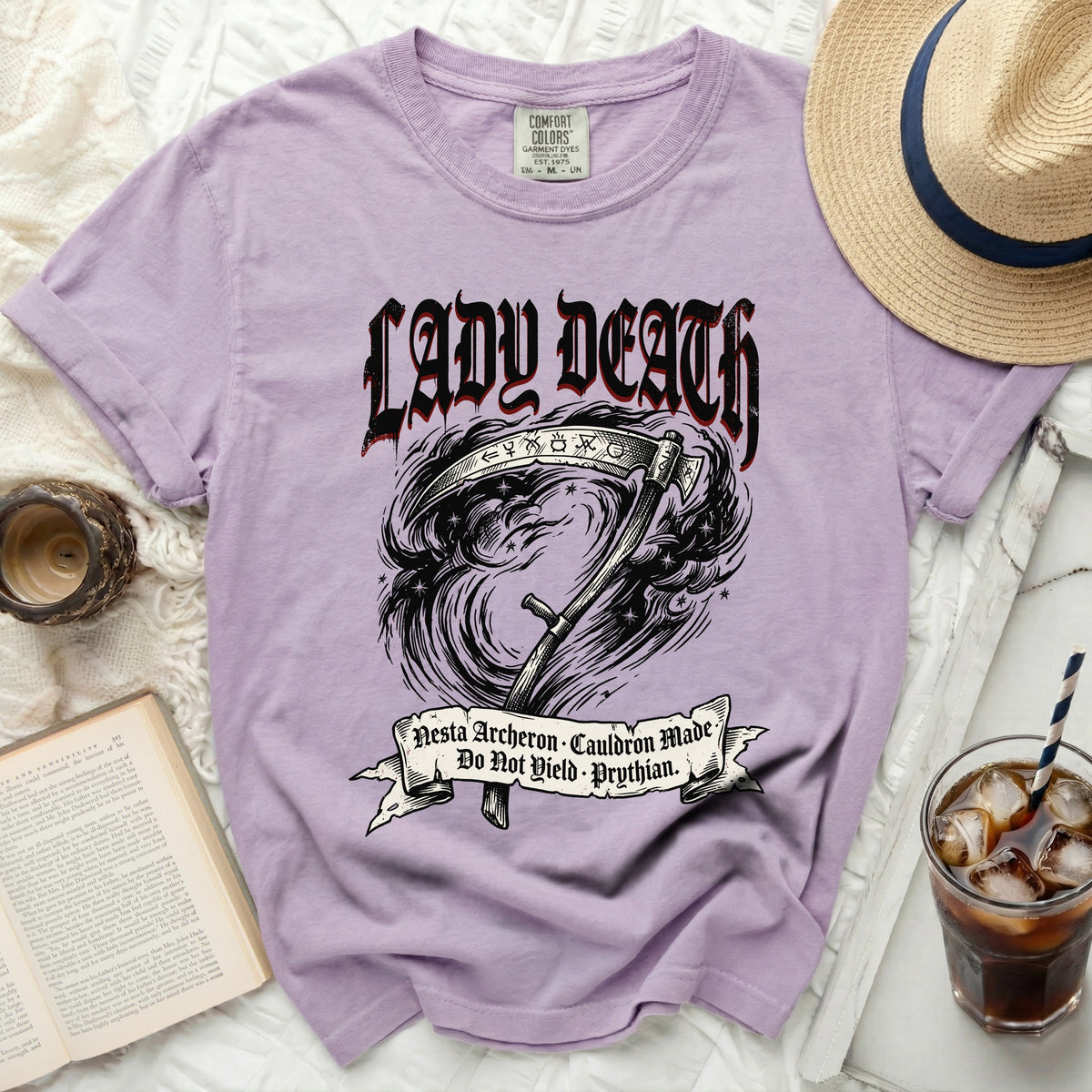 Lavender t-shirt with "Lady Death" graphic and scythe.