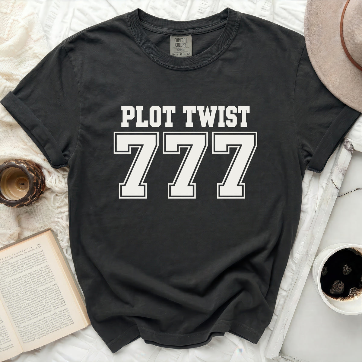 Black t-shirt with "PLOT TWIST 777" in white block letters.