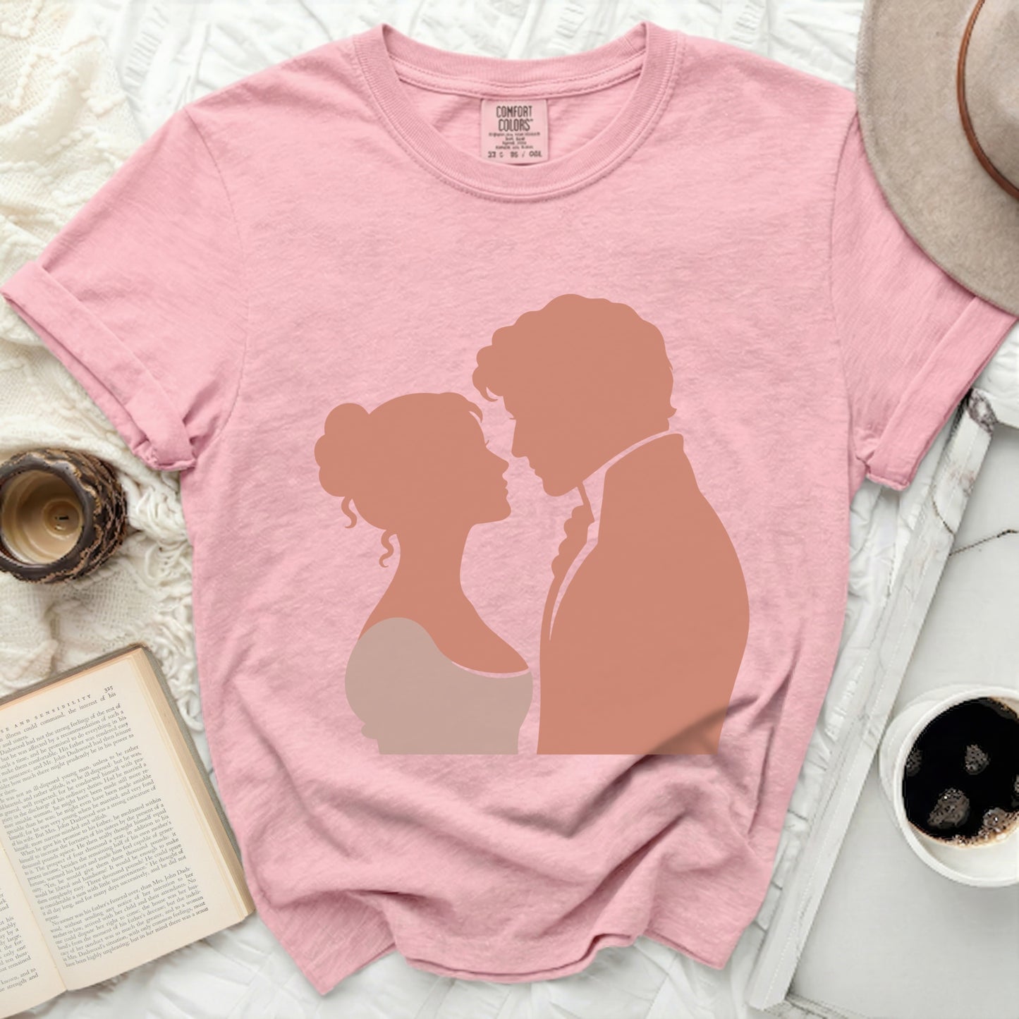 Pink t-shirt with silhouette of a couple facing each other.