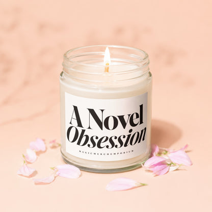 Candle with "A Novel Obsession" text on label with pink petals.