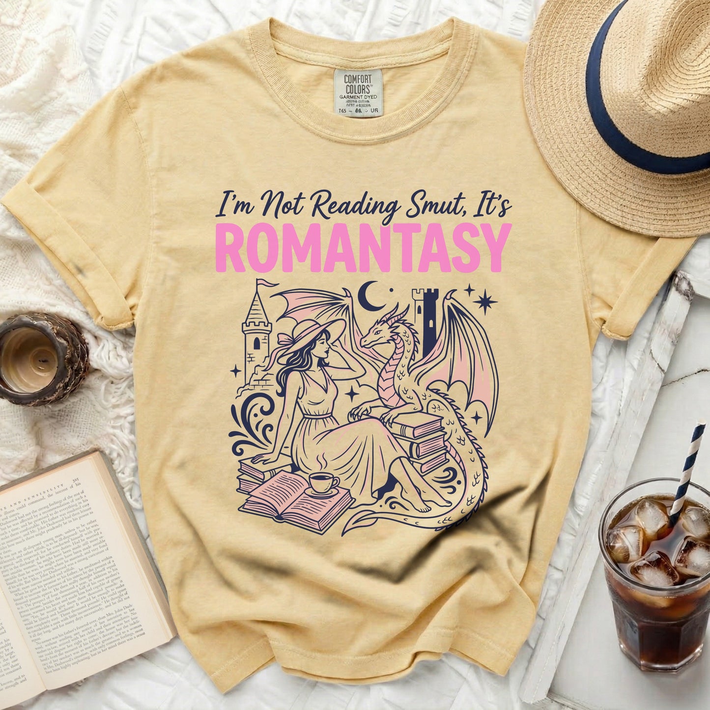 Yellow t-shirt with "I'm Not Reading Smut, It's ROMANTASY" text and a woman with a dragon.