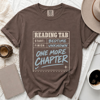 Brown t-shirt with "Reading Tab: Start Bedtime, Finish Unknown, One More Chapter" text.
