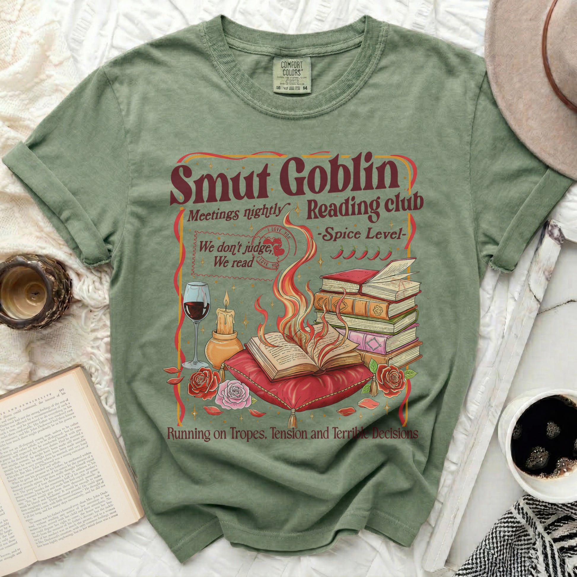 Green t-shirt with "Smut Goblin Reading Club" graphic featuring books and flames.