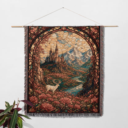a tapestry hanging on a wall, depicting a serene landscape with a deer standing in the foreground and mountains in the background.
