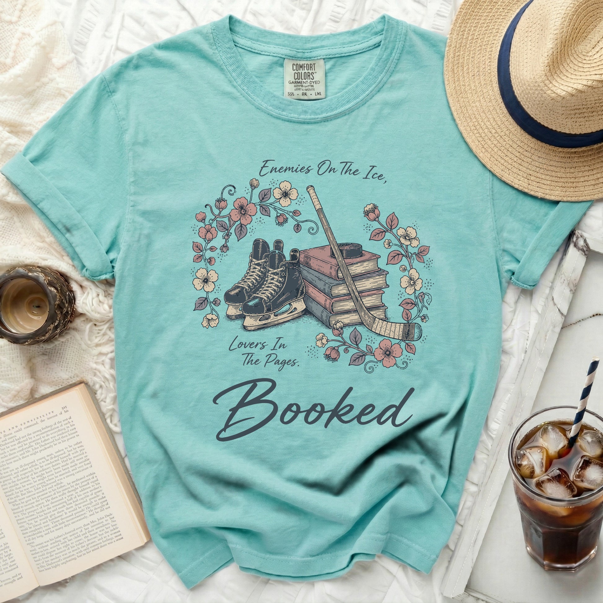 Teal t-shirt with hockey skates, books, and floral wreath.