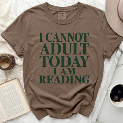Brown t-shirt with "I cannot adult today I am reading" text.
